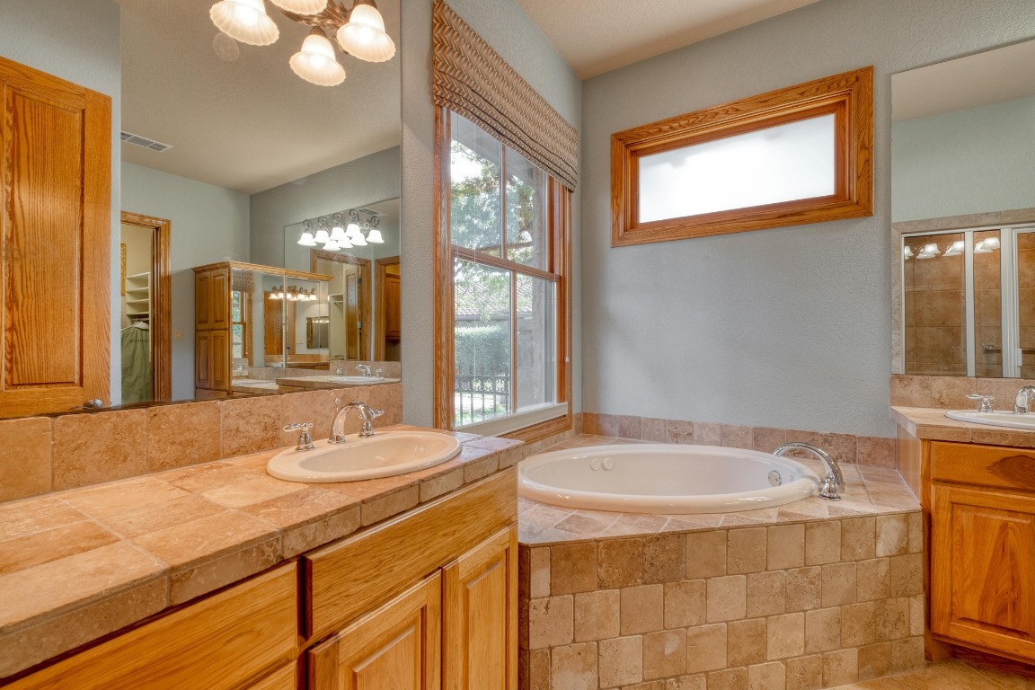 205 Flint Ridge Trail Georgetown, TX 78628 - Photo 21 of 40 a bathroom with a granite countertop sink and a mirror