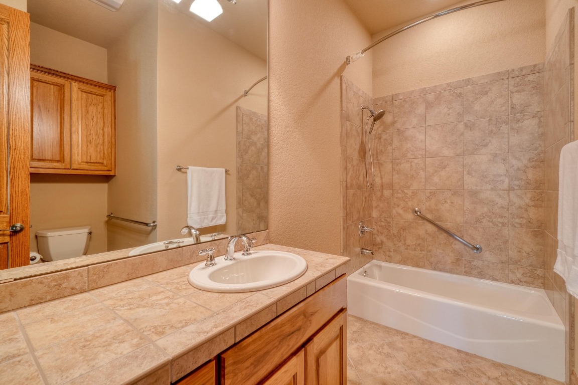 205 Flint Ridge Trail Georgetown, TX 78628 - Photo 27 of 40 a bathroom with a granite countertop sink and a bathtub