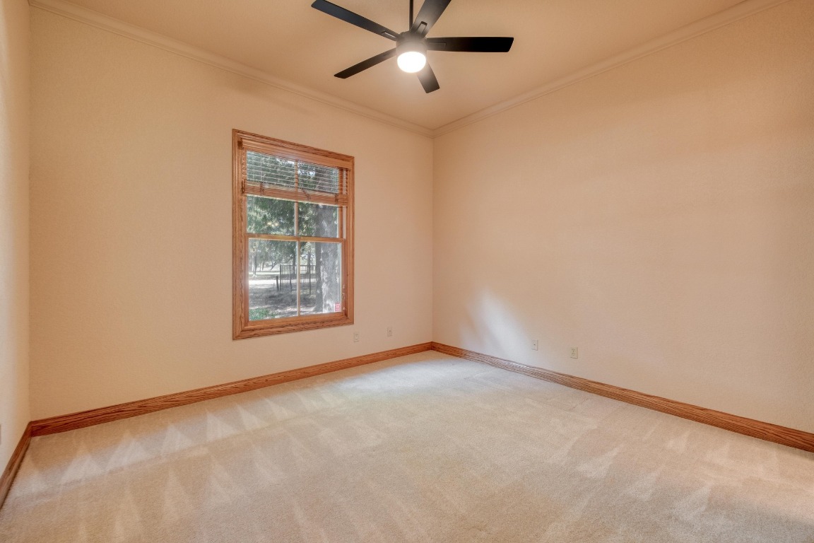 205 Flint Ridge Trail Georgetown, TX 78628 - Photo 28 of 40 an empty room with windows and fan