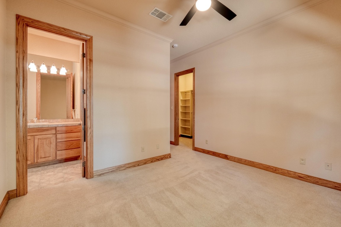 205 Flint Ridge Trail Georgetown, TX 78628 - Photo 29 of 40 an empty room with closet and a chandelier fan