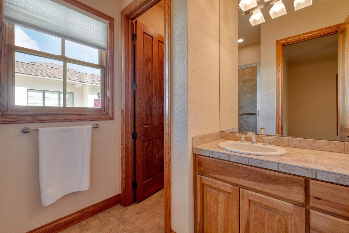 205 Flint Ridge Trail Georgetown, TX 78628 - Photo 30 of 40 a bathroom with a sink and a mirror