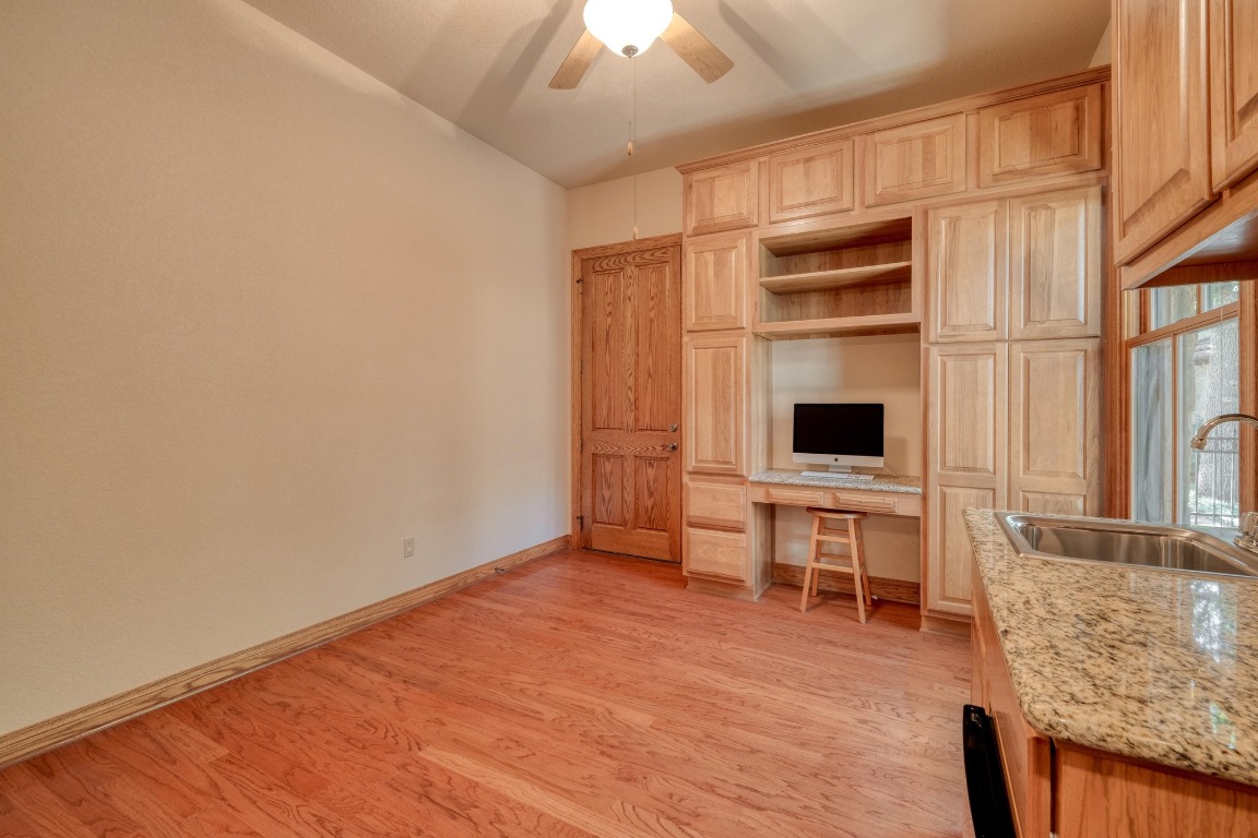 205 Flint Ridge Trail Georgetown, TX 78628 - Photo 32 of 40 an empty room with wooden floor cabinet and windows