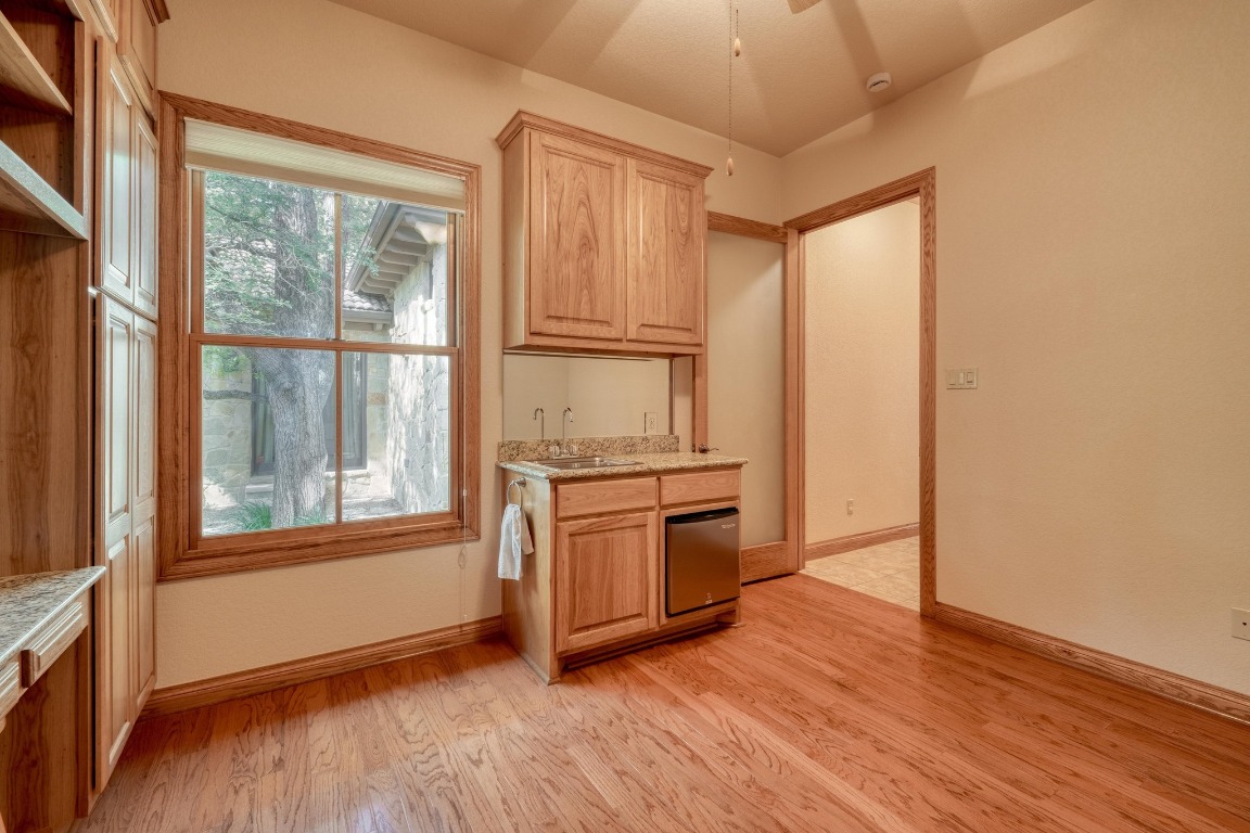 205 Flint Ridge Trail Georgetown, TX 78628 - Photo 33 of 40 a view of a kitchen with a stove cabinets and wooden floor
