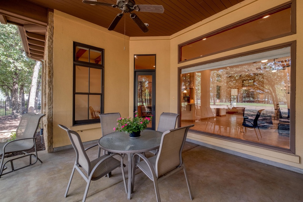 205 Flint Ridge Trail Georgetown, TX 78628 - Photo 36 of 40 a dining room with furniture wooden floor and a chandelier