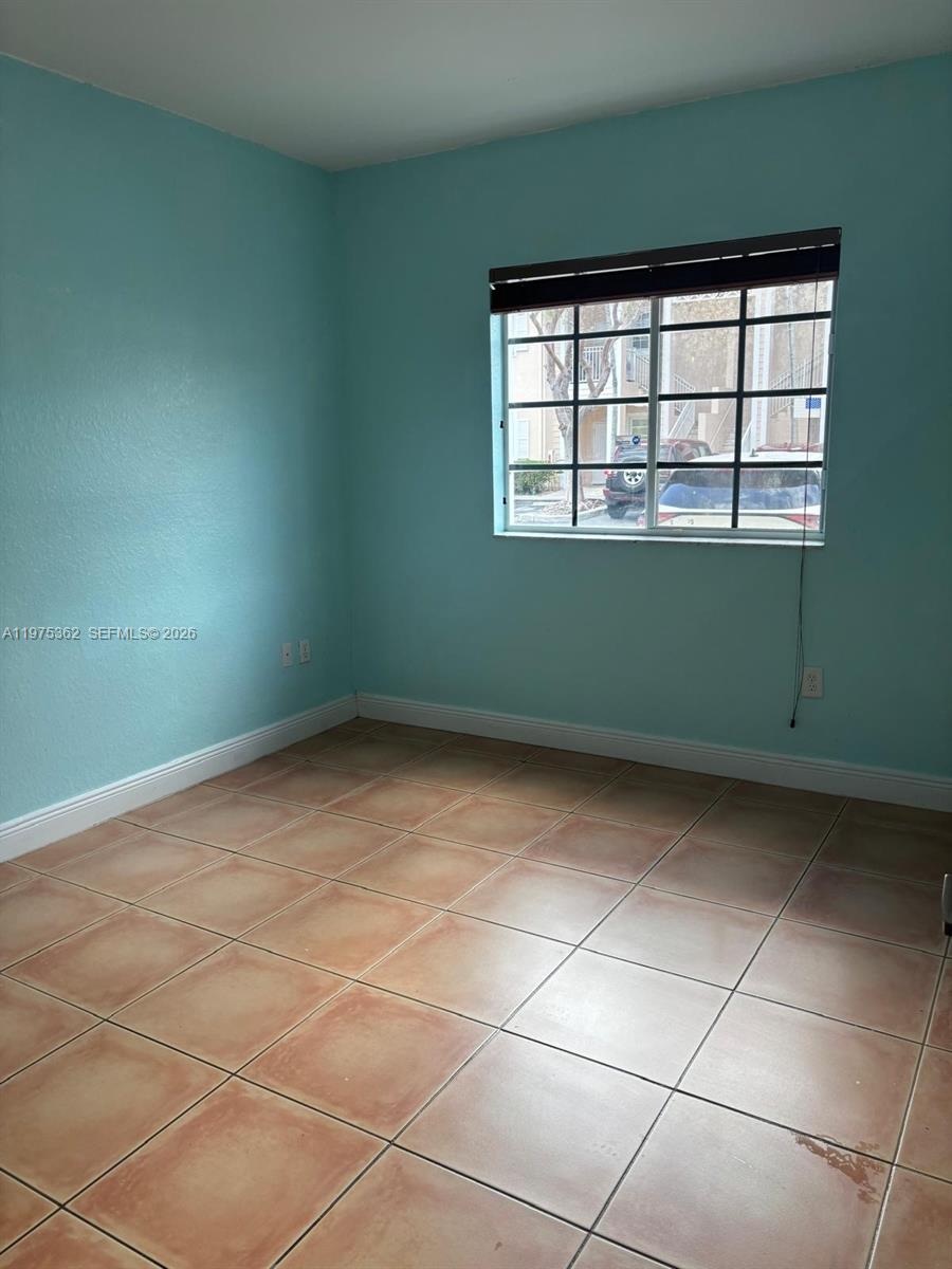371 Northeast 26th Terrace, Unit 101 Homestead, FL 33033 - Photo 3 of 10 a view of empty room with windows
