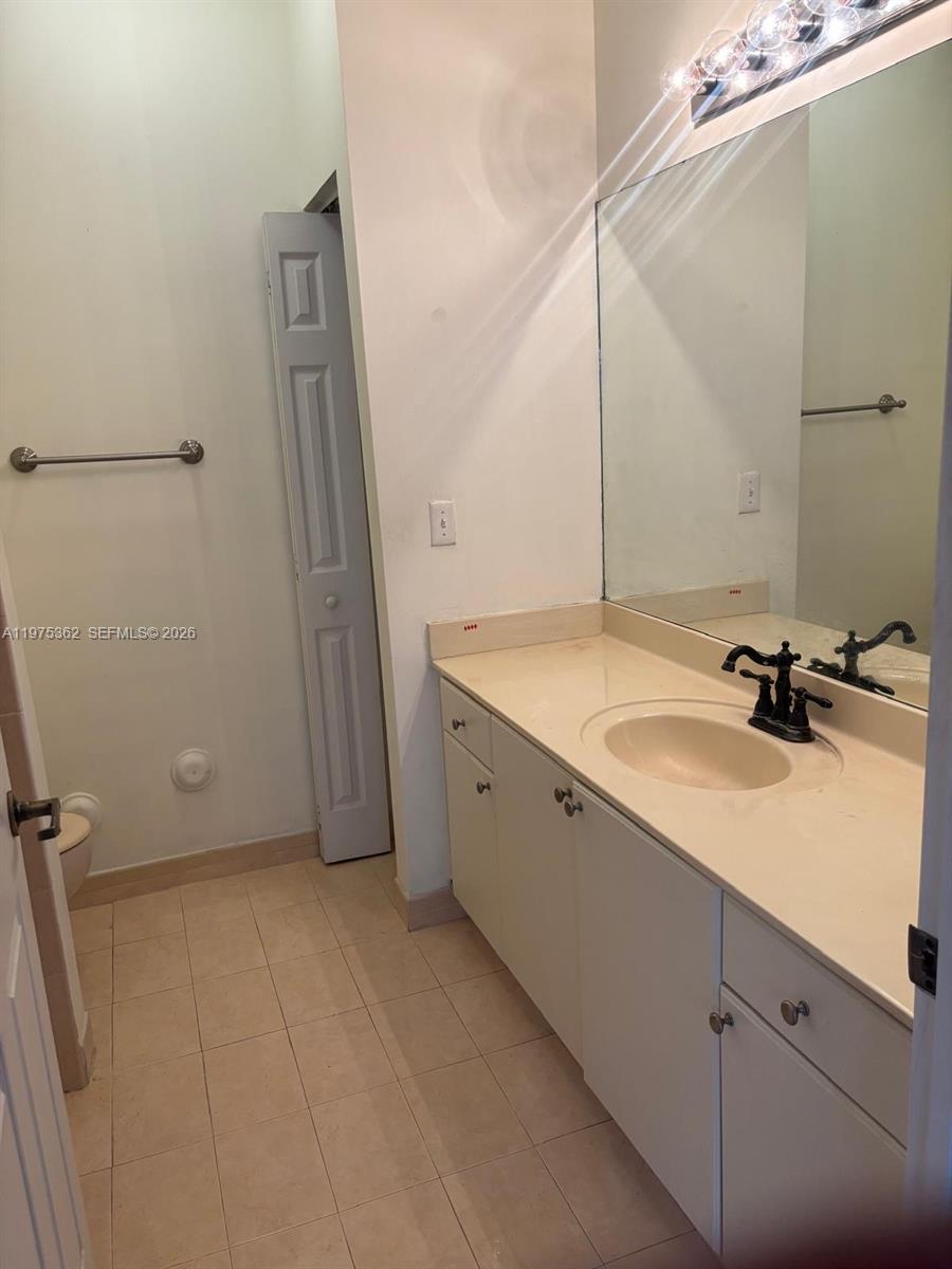 371 Northeast 26th Terrace, Unit 101 Homestead, FL 33033 - Photo 10 of 10 a bathroom with a sink and mirror