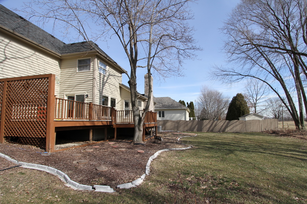 2165 Hidden Valley Drive Naperville, IL 60565 - Photo 26 of 29 a view of a house with a yard next to a road