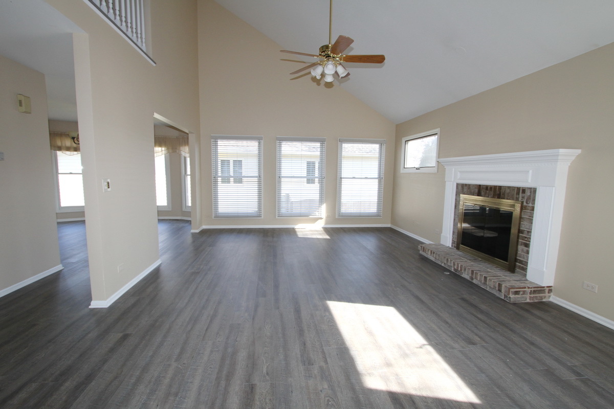 2165 Hidden Valley Drive Naperville, IL 60565 - Photo 4 of 29 wooden floor in an empty room with a fireplace