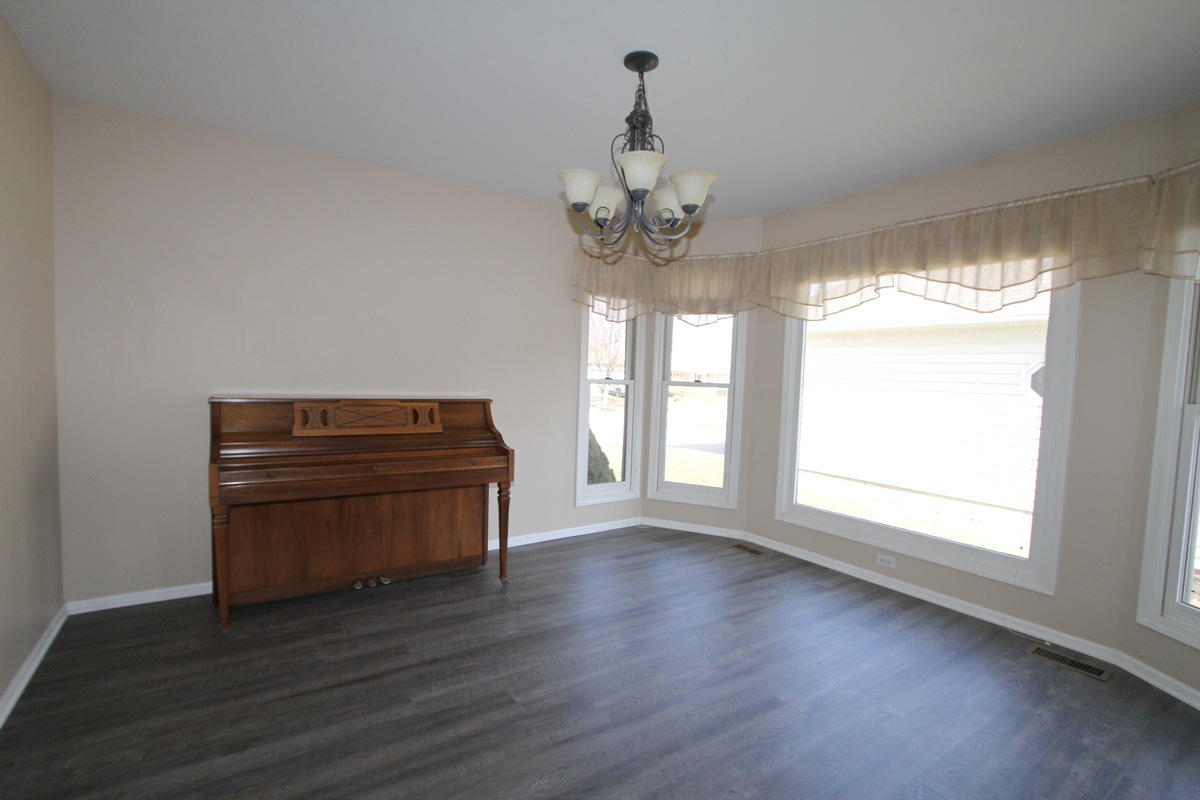 2165 Hidden Valley Drive Naperville, IL 60565 - Photo 6 of 29 a room with wooden floors and large windows