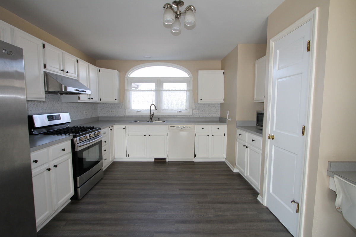 2165 Hidden Valley Drive Naperville, IL 60565 - Photo 9 of 29 a large kitchen with stainless steel appliances granite countertop a stove a sink dishwasher and a refrigerator with wooden floors