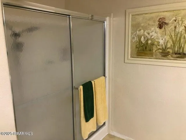 a bathroom with a shower and a glass door