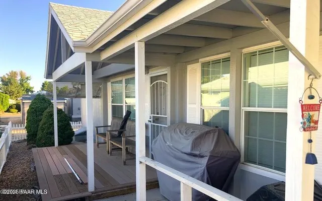 a view of balcony with furniture and garden