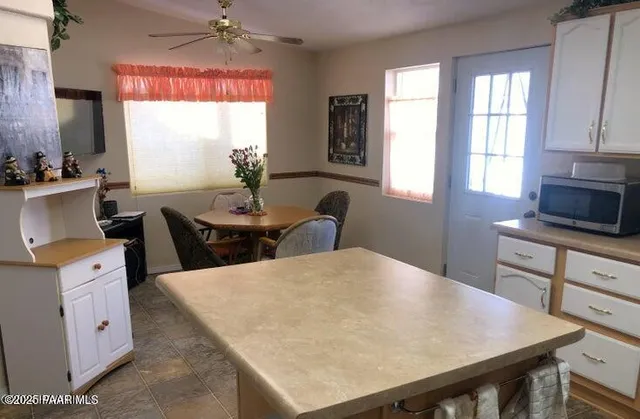 a kitchen with a table chairs and window