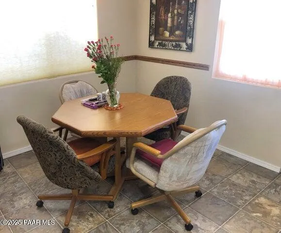 a dining room with furniture and wooden floor