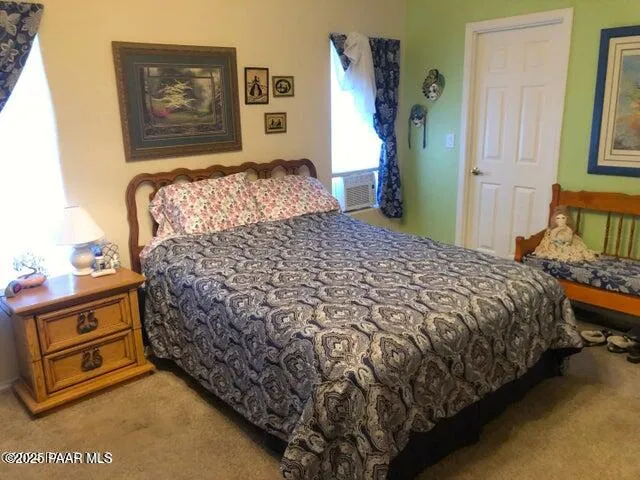 a bed sitting in a bedroom next to a window with bed