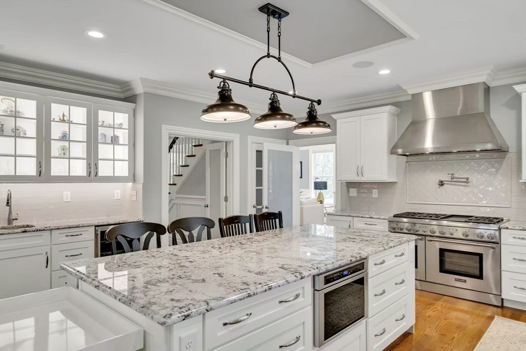 311 Concord Avenue Lexington, MA 02421 - Photo 11 of 28 a kitchen with granite countertop a stove and a sink