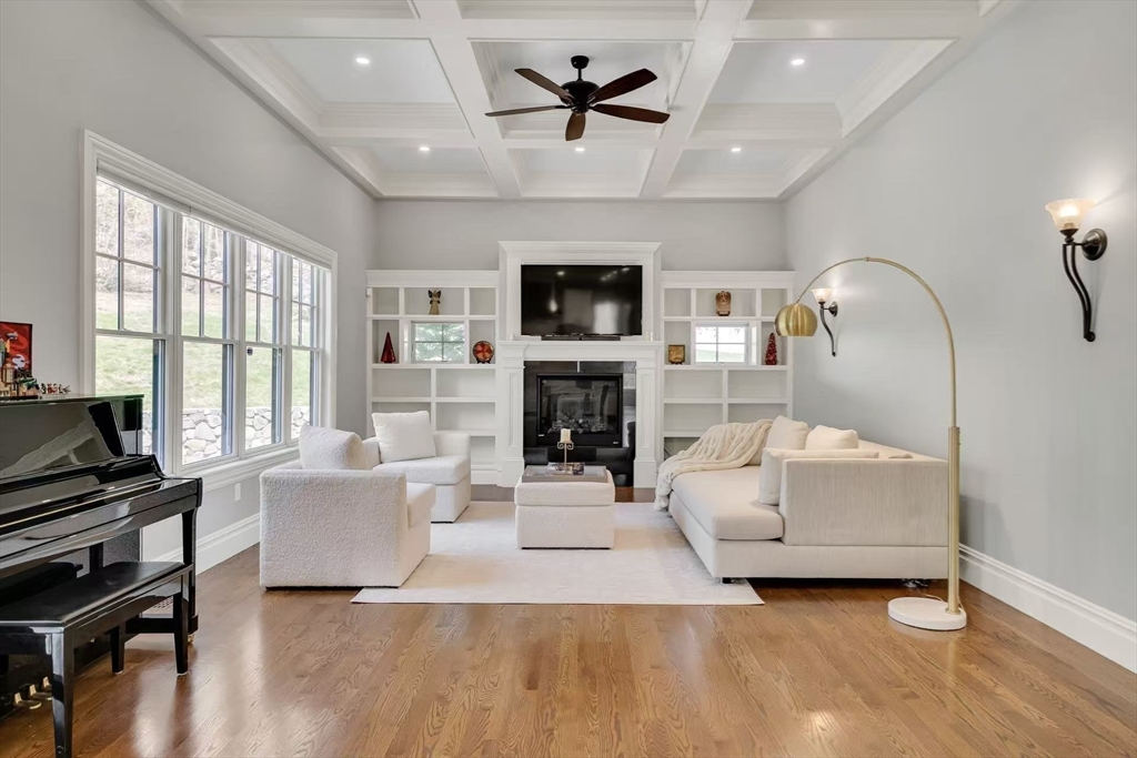 311 Concord Avenue Lexington, MA 02421 - Photo 12 of 28 a living room with furniture a flat screen tv and a fireplace