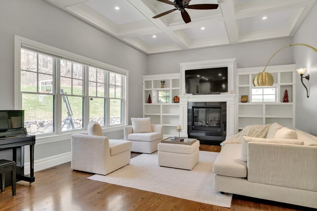 311 Concord Avenue Lexington, MA 02421 - Photo 13 of 28 a living room with furniture a flat screen tv and a fireplace