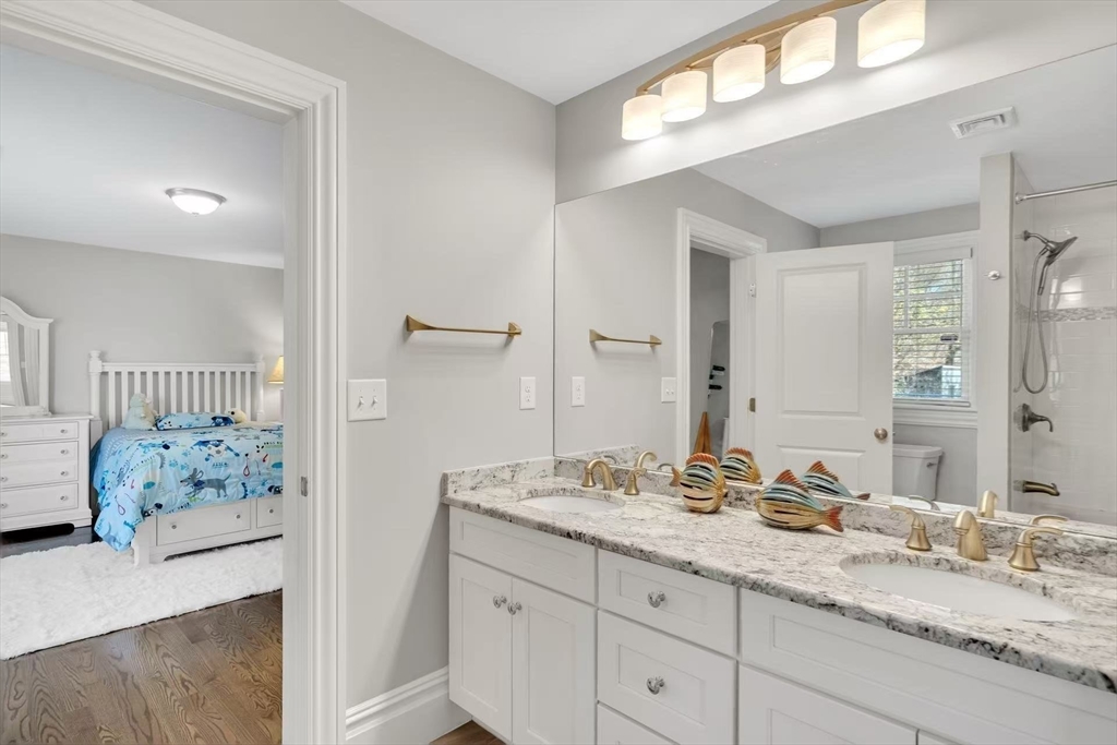 311 Concord Avenue Lexington, MA 02421 - Photo 16 of 28 a bathroom with a granite countertop sink and a mirror