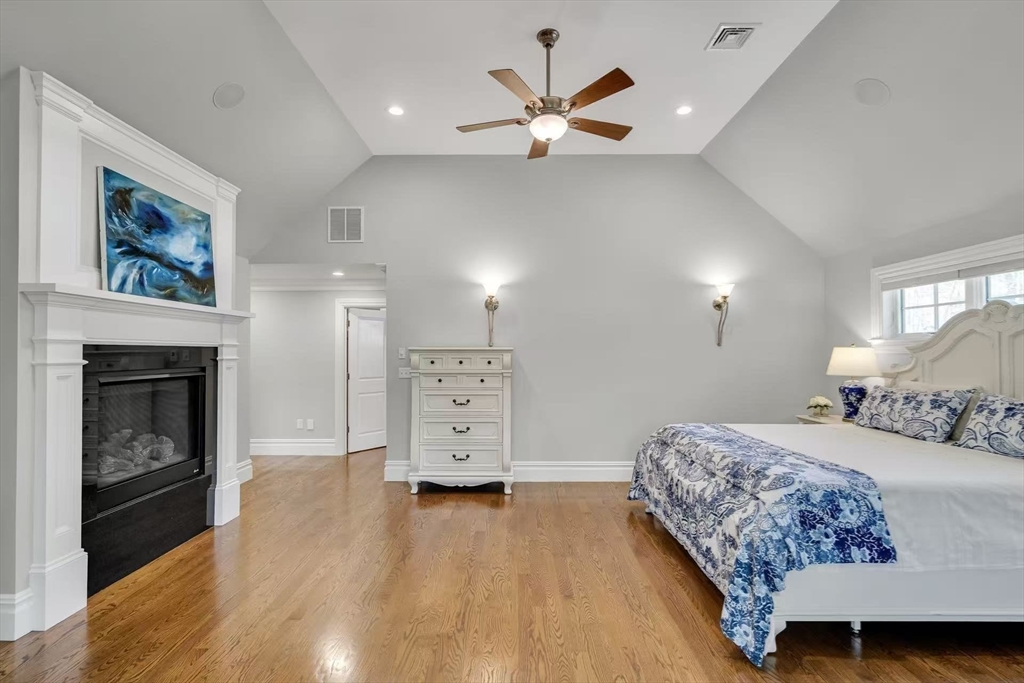 311 Concord Avenue Lexington, MA 02421 - Photo 20 of 28 a bedroom with a bed and a fireplace