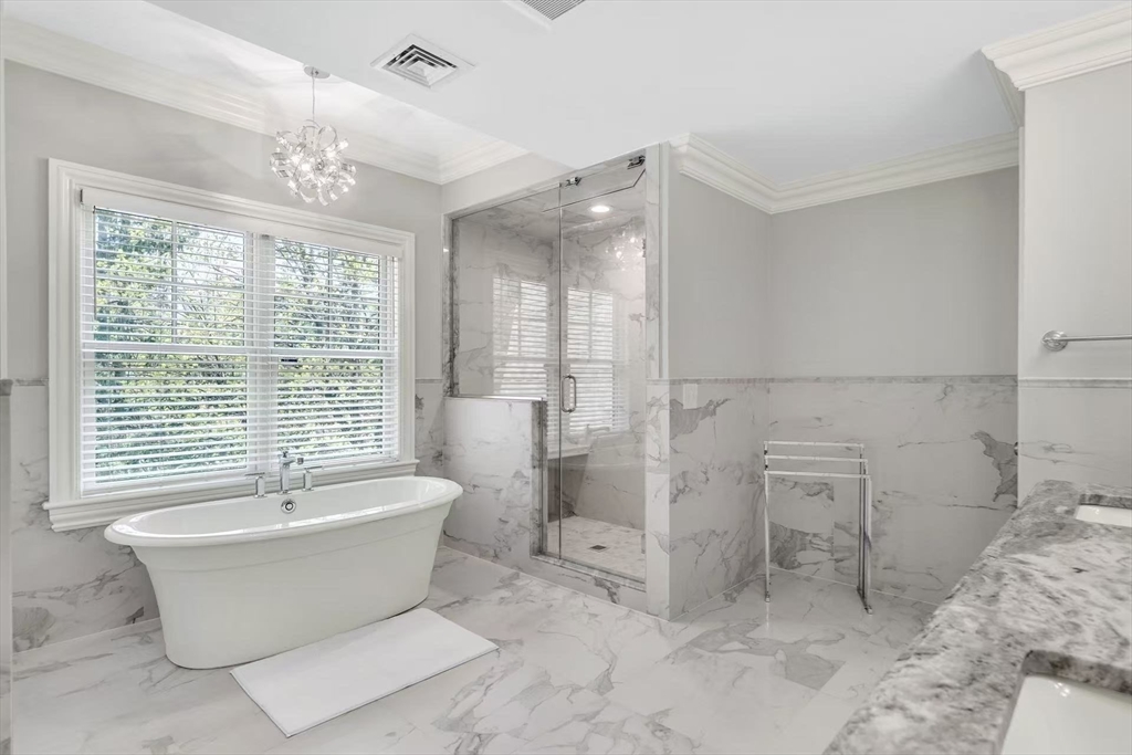 311 Concord Avenue Lexington, MA 02421 - Photo 22 of 28 a bathroom with a bathtub and window