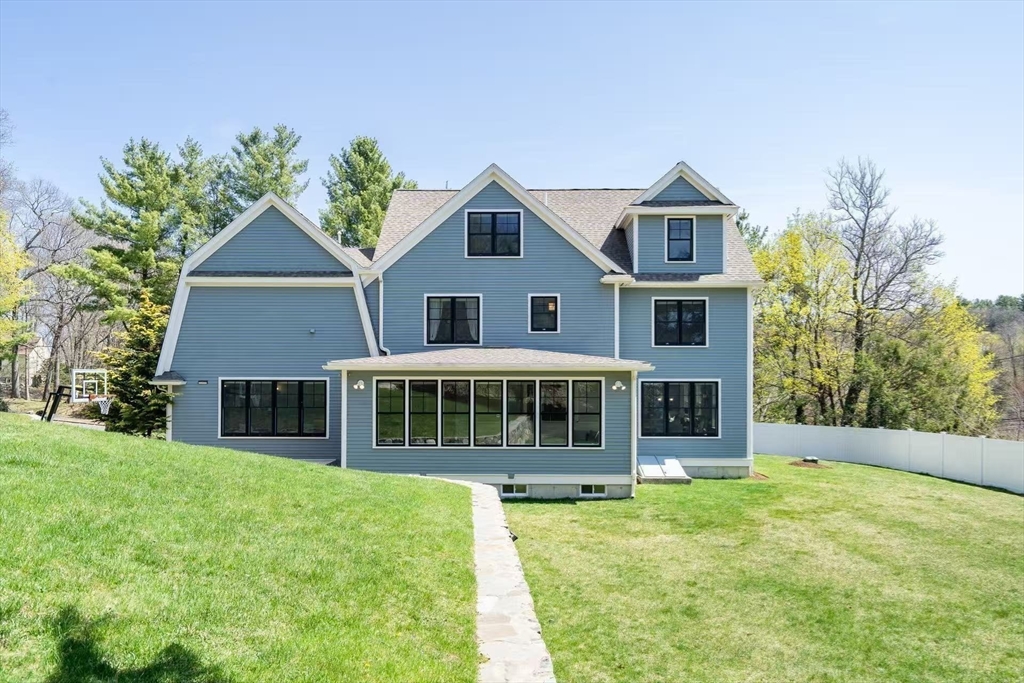 311 Concord Avenue Lexington, MA 02421 - Photo 27 of 28 a front view of a house with a yard table and chairs