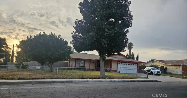 a view of house with outdoor space and parking