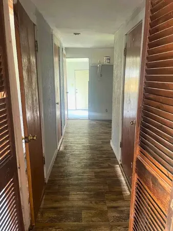 a view of a hallway with wooden floor