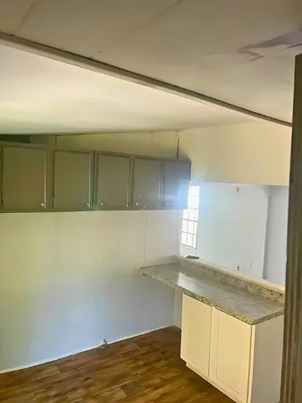 a view of storage and utility room with wooden floor