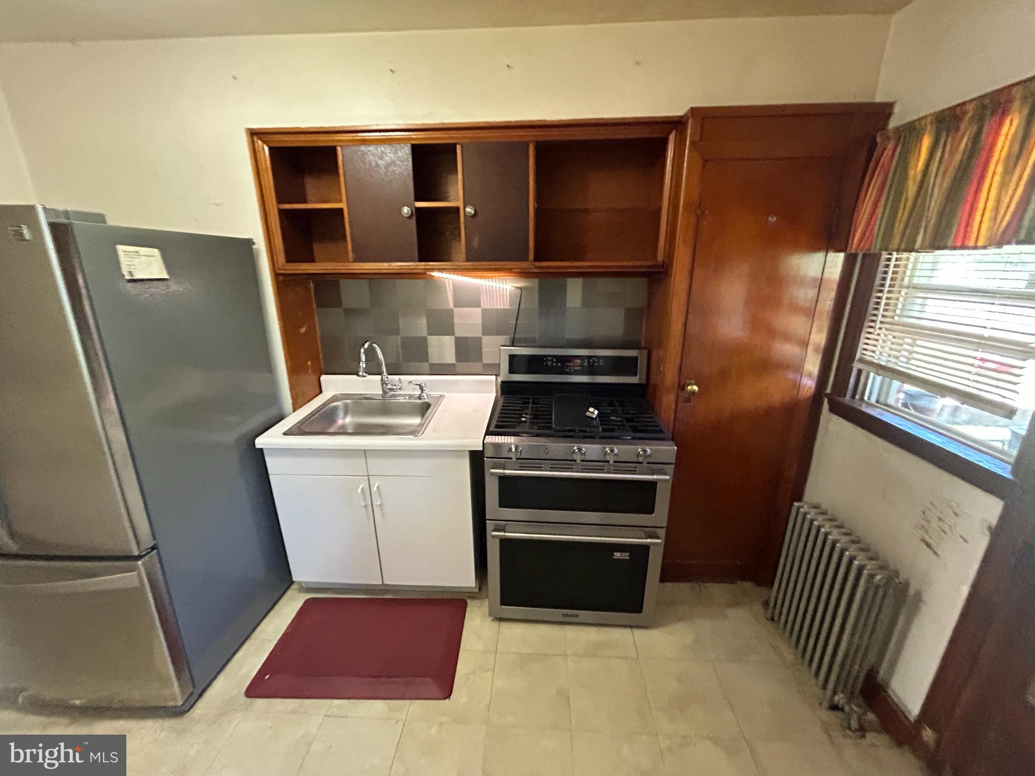 4014 Century Road Baltimore, MD 21206 - Photo 9 of 19 a kitchen with a refrigerator and a stove