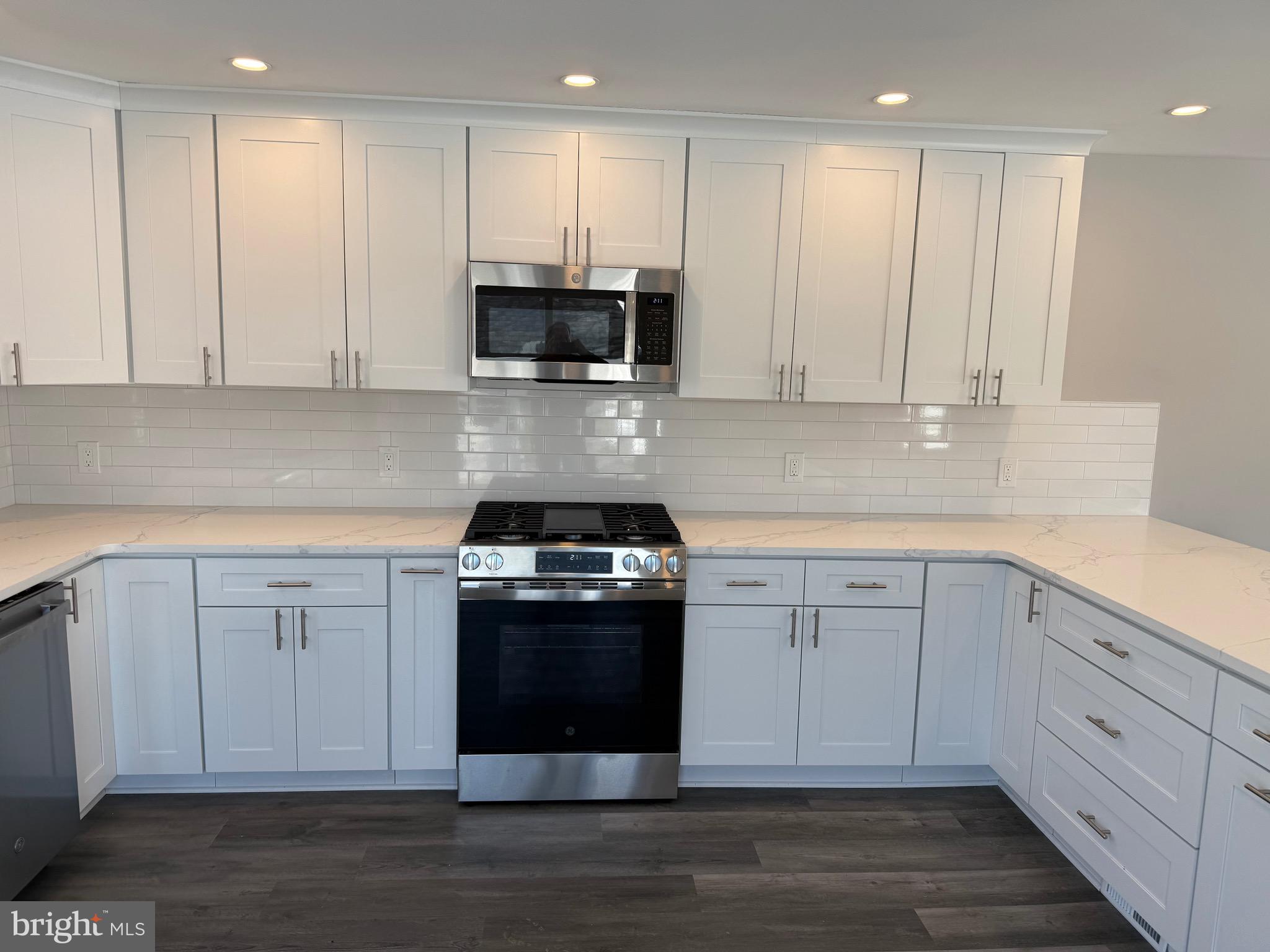 204 3rd Avenue West Berlin, NJ 08091 - Photo 3 of 19 a kitchen with stainless steel appliances granite countertop a stove a sink and white cabinets
