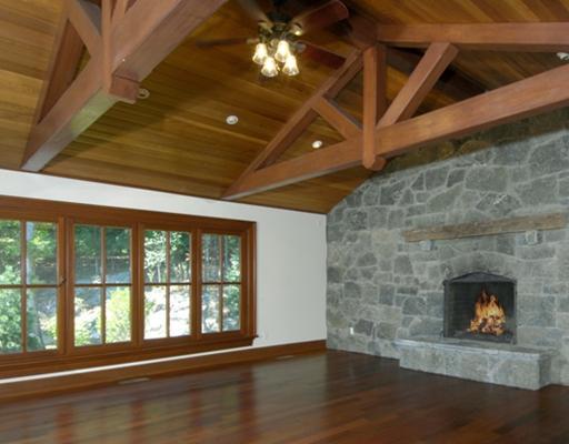 Undisclosed Address Cos Cob, CT 06807 - Photo 6 of 10 a living room with a fireplace a large window and wooden floor