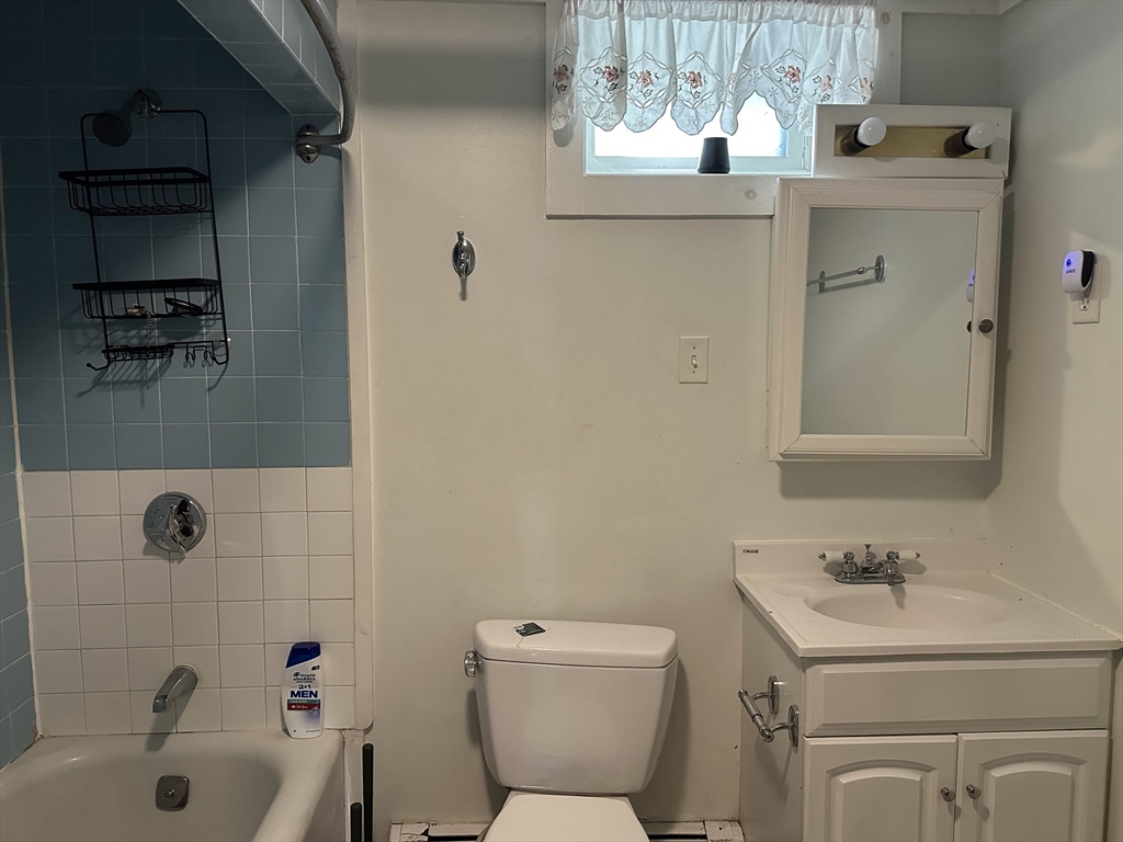 90 Massasoit Street, Unit 90 Waltham, MA 02453 - Photo 11 of 15 a bathroom with a sink a toilet and shower