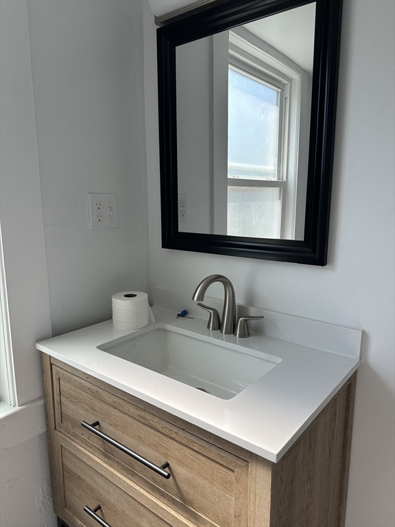 90 Massasoit Street, Unit 90 Waltham, MA 02453 - Photo 13 of 15 a bathroom with a sink and a mirror