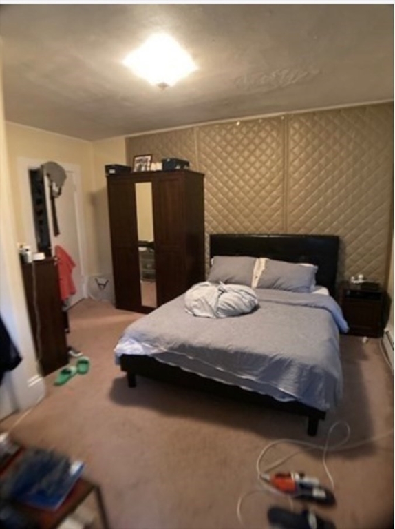 90 Massasoit Street, Unit 90 Waltham, MA 02453 - Photo 4 of 15 a bedroom with a bed and dresser