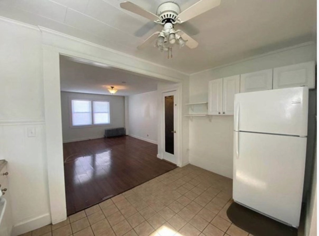 90 Massasoit Street, Unit 90 Waltham, MA 02453 - Photo 5 of 15 a view of a hallway with a refrigerator