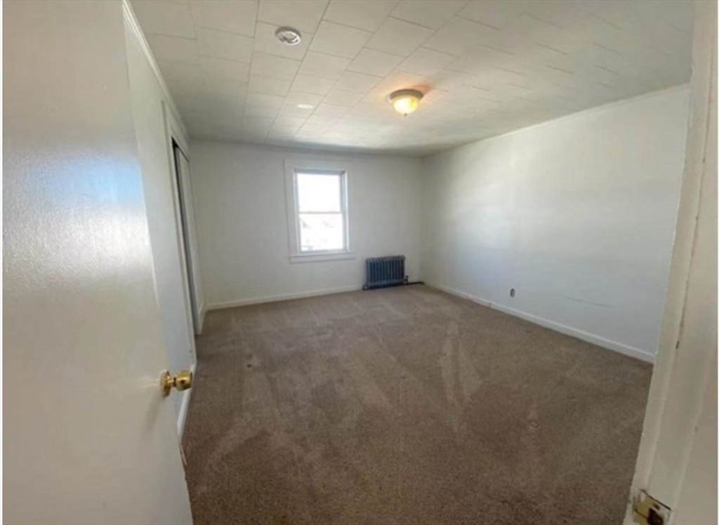 90 Massasoit Street, Unit 90 Waltham, MA 02453 - Photo 8 of 15 an empty room with windows