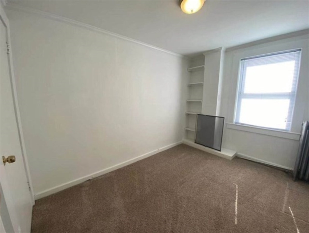 90 Massasoit Street, Unit 90 Waltham, MA 02453 - Photo 9 of 15 an empty room with windows