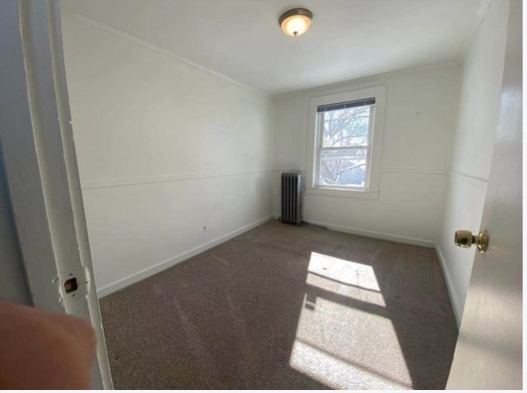 90 Massasoit Street, Unit 90 Waltham, MA 02453 - Photo 10 of 15 a view of an empty room and window