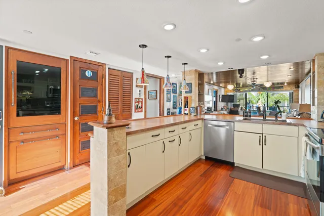 a kitchen with stainless steel appliances granite countertop cabinets and wooden floor