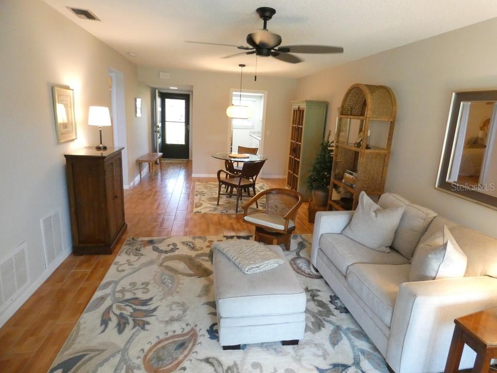 1701 Pinehurst Road, Unit 9G Dunedin, FL 34698 - Photo 2 of 22 a living room with furniture and wooden floor