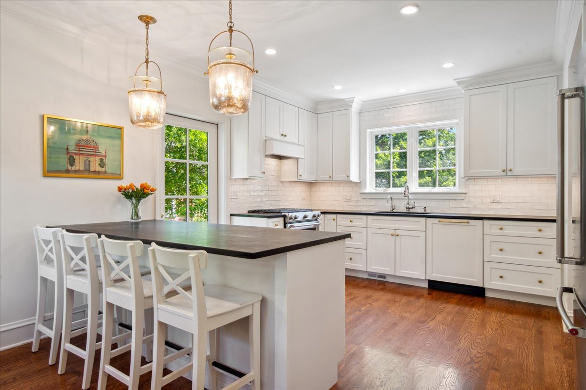 2429 Prospect Avenue Evanston, IL 60201 - Photo 11 of 31 a kitchen with stainless steel appliances granite countertop a sink a stove and a wooden floors