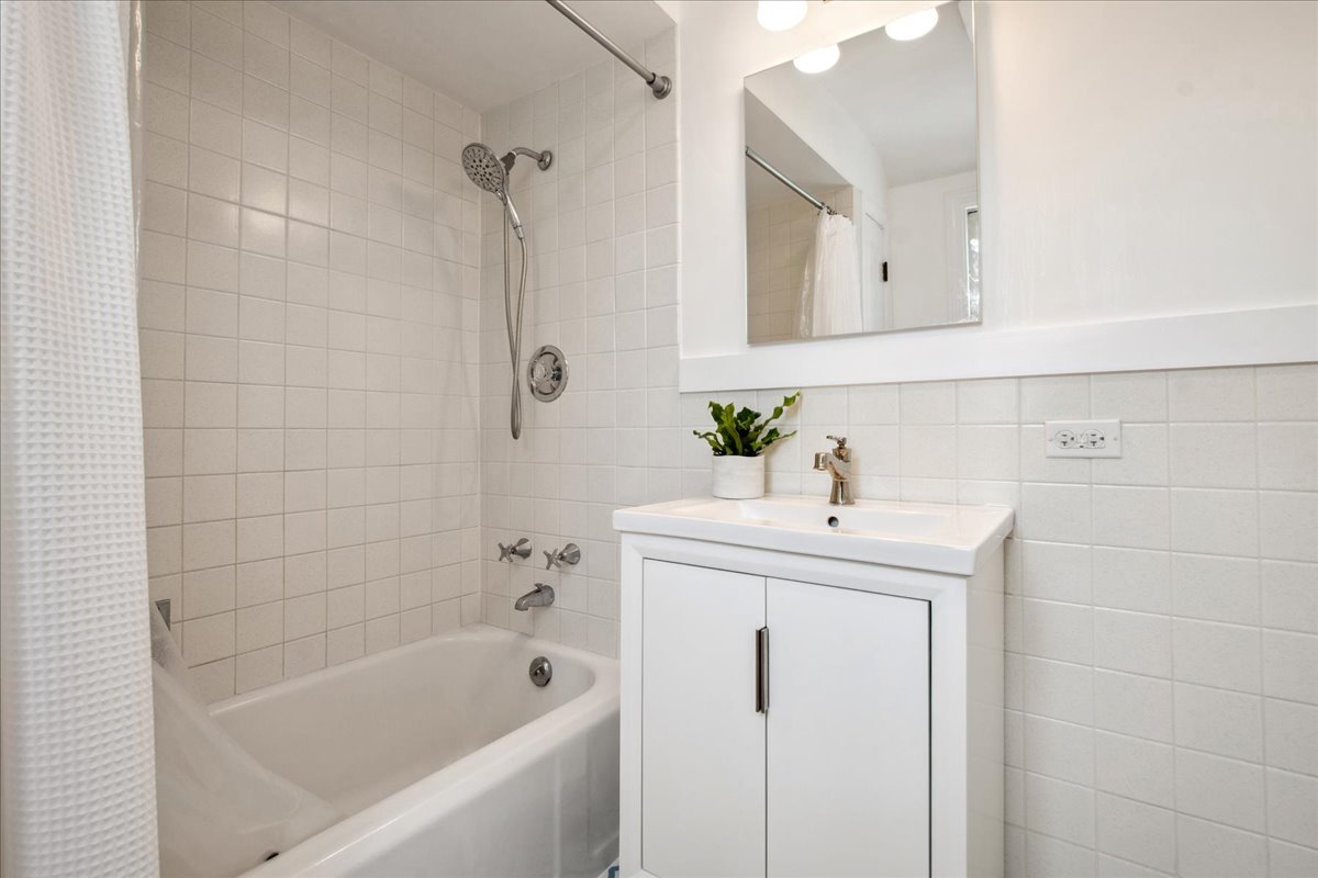 2429 Prospect Avenue Evanston, IL 60201 - Photo 19 of 31 a bathroom with a sink a bathtub and a shower