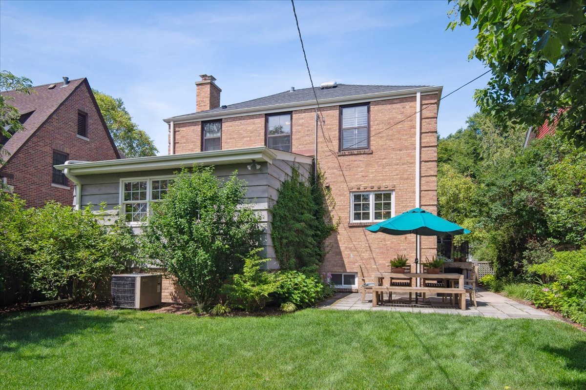 2429 Prospect Avenue Evanston, IL 60201 - Photo 24 of 31 a front view of a house with a yard table and chairs