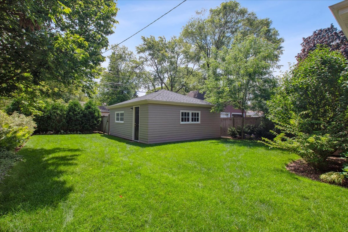 2429 Prospect Avenue Evanston, IL 60201 - Photo 27 of 31 a backyard of a house with plants and large tree