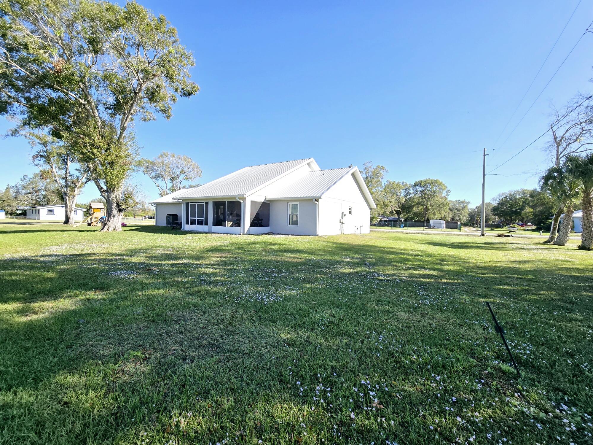 603 Northwest 11th Avenue Okeechobee, FL 34972 - Photo 5 of 28 a view of a house with a big yard