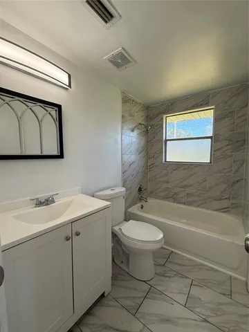 a bathroom with a sink a toilet and bathtub