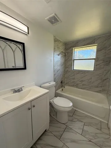 a bathroom with a sink a toilet and bathtub