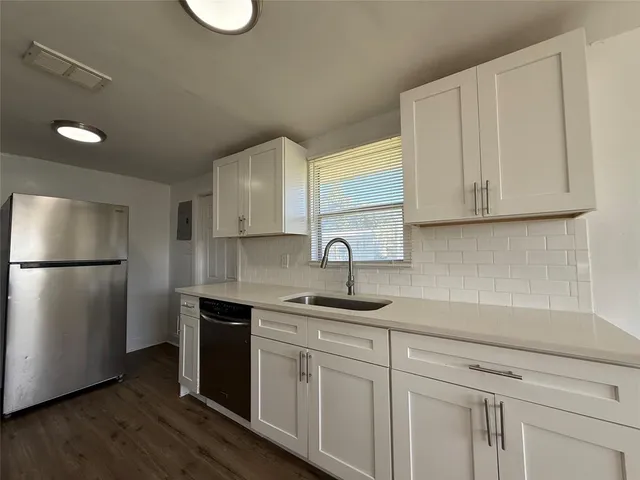 a kitchen with a sink cabinets and stainless steel appliances