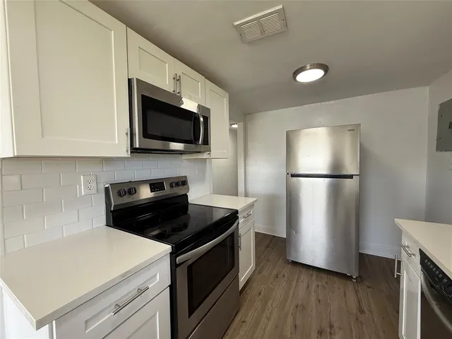a kitchen with a refrigerator stove and microwave